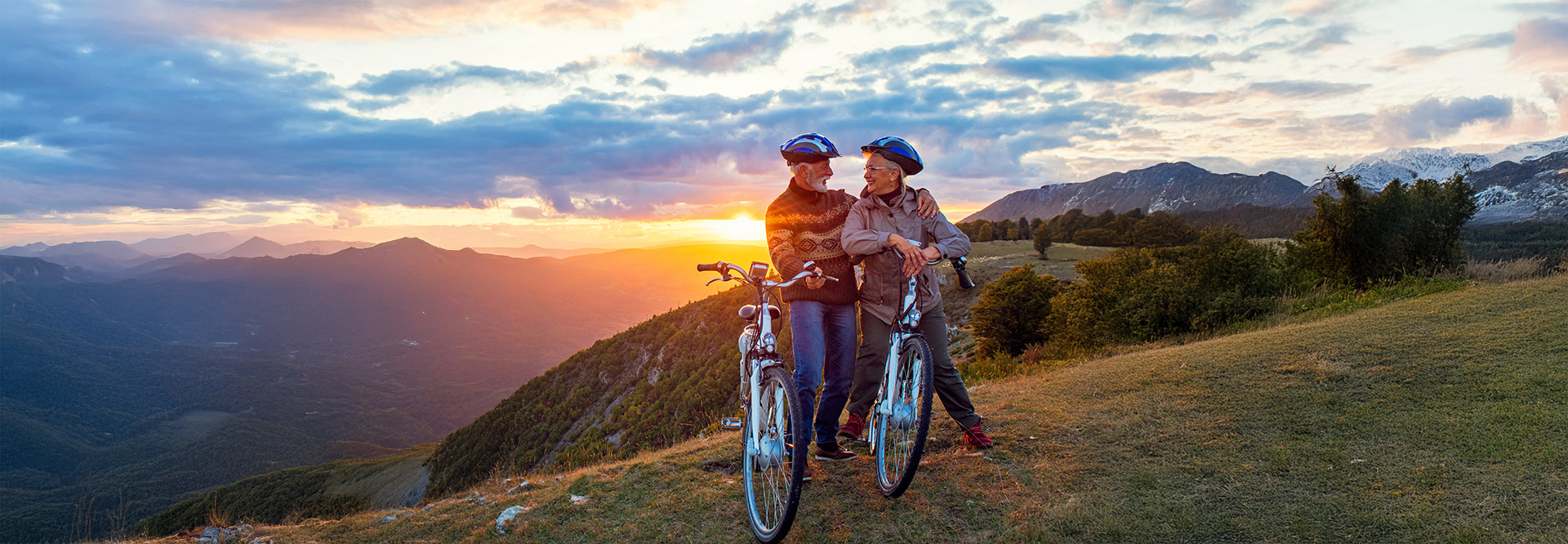 adventurous older couple riding bikes in the mountains
