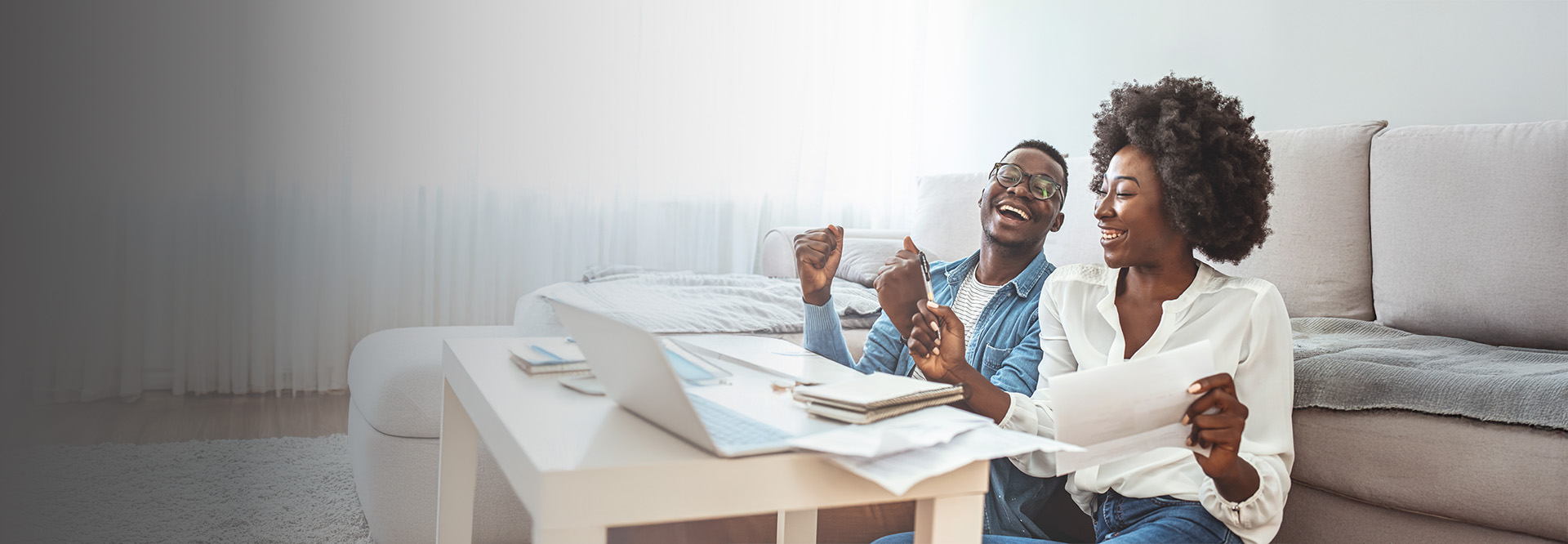 middle aged couple smiling at computer