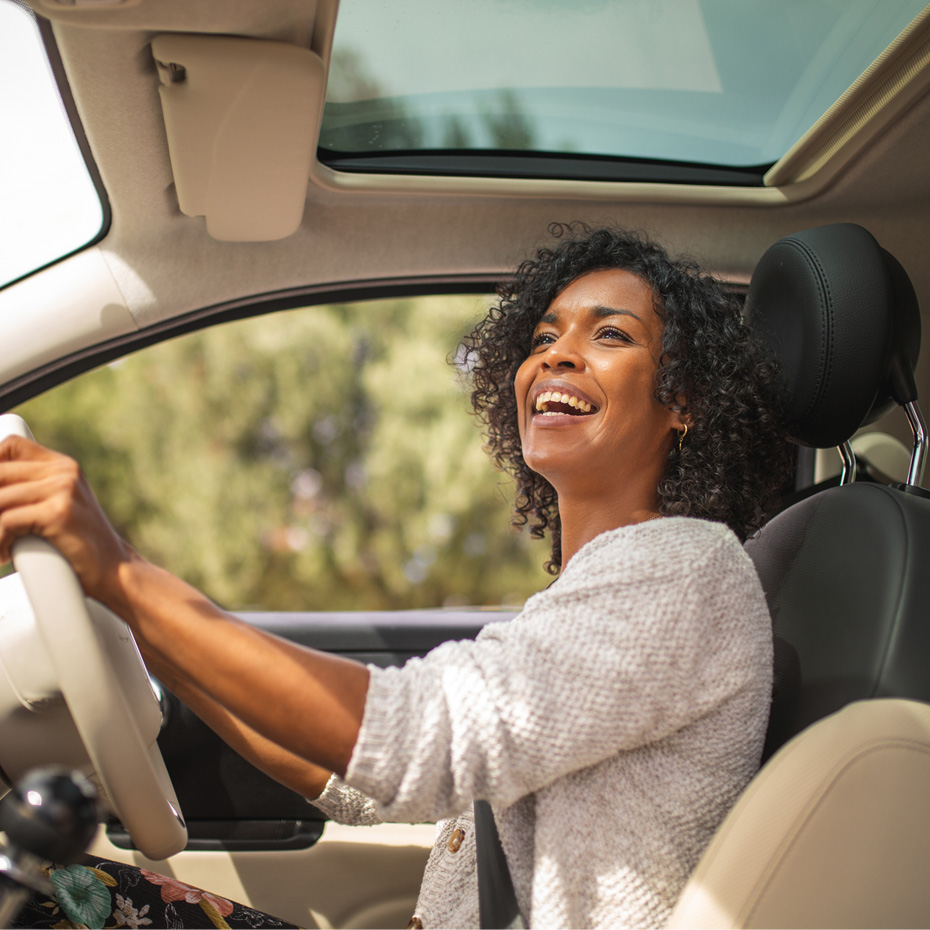woman driving and smiling